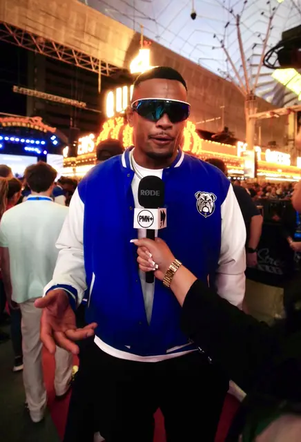 PMN+ host with a mic on the street at night