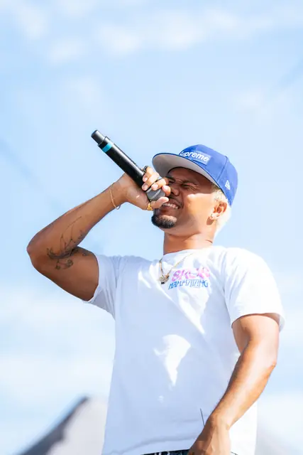Artist in a blue cap performing outdoors