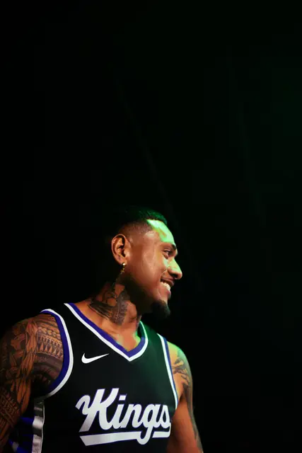 Singer in a Kings jersey on a dark stage
