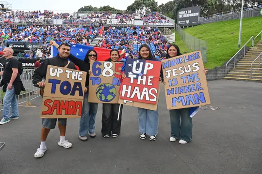 Fans holding Up the Toa signs at the stadium