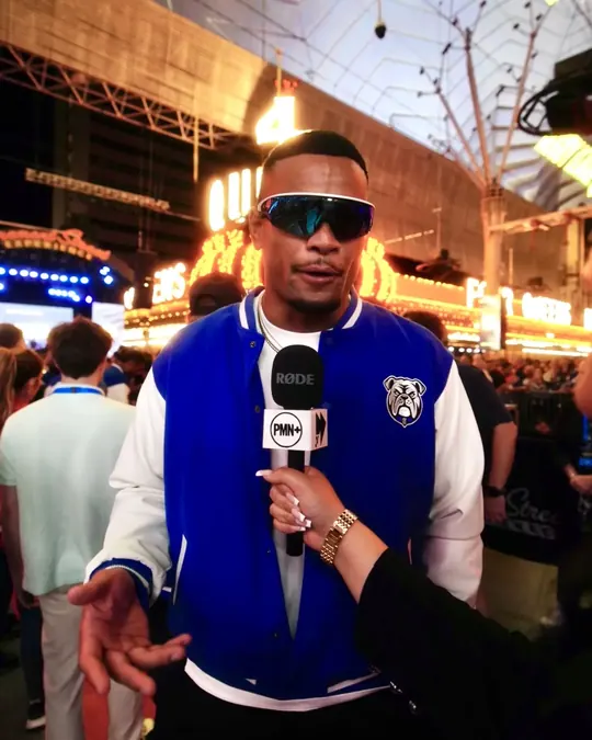 PMN+ host with a mic on the street at night